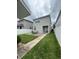 An inviting backyard features a stone patio, green lawn, and a view of the home's exterior at 11097 N Folklore St, Winter Garden, FL 34787