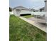 A backyard with a small patio set, grassy area, and white fence offers a relaxing outdoor space at 11097 N Folklore St, Winter Garden, FL 34787