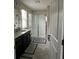 Bathroom with sliding door shower, vanity with granite countertop and grey ceramic flooring at 11097 N Folklore St, Winter Garden, FL 34787