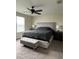 Spacious bedroom with carpet flooring, ceiling fan and bench seating at the end of the bed at 11097 N Folklore St, Winter Garden, FL 34787