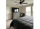 Bedroom featuring a dresser with a TV on top, and a bed with a dark comforter at 11097 N Folklore St, Winter Garden, FL 34787
