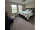 Neutral bedroom featuring two windows and a ceiling fan at 11097 N Folklore St, Winter Garden, FL 34787