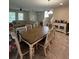 Well-lit dining room showcasing a wooden table with seating, tile flooring, and an open layout at 11097 N Folklore St, Winter Garden, FL 34787