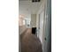 Neutral hallway with carpet, neutral paint, and white trim on the doors at 11097 N Folklore St, Winter Garden, FL 34787