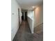 Upstairs hallway with carpet flooring, white walls and trim, and doors to bedrooms or storage spaces at 11097 N Folklore St, Winter Garden, FL 34787