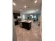 Modern kitchen with a central island, stainless steel appliances, and open views to the living area at 11097 N Folklore St, Winter Garden, FL 34787
