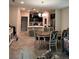 Open-concept kitchen featuring dark cabinetry, a central island with bar seating, and an adjacent dining area at 11097 N Folklore St, Winter Garden, FL 34787