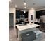 Modern kitchen features a center island, stainless steel appliances, and dark cabinets at 11097 N Folklore St, Winter Garden, FL 34787