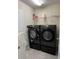 Modern laundry room featuring newer black Samsung washer and dryer set, white cabinets, and shelving at 11097 N Folklore St, Winter Garden, FL 34787