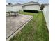 Patio with table and chair setting in a yard with green grass at 11097 N Folklore St, Winter Garden, FL 34787