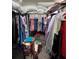 Walk-in closet with hanging clothes on both sides, and overhead storage space at 11097 N Folklore St, Winter Garden, FL 34787