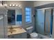 Clean bathroom with a vanity, toilet, and walk-in shower with sliding glass doors at 114 Madeira Ave, Orlando, FL 32825