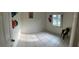 Empty bedroom features tile flooring, a bright window, and ample sunlight at 114 Madeira Ave, Orlando, FL 32825