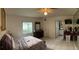 Bright bedroom with a large bed, window view, and ensuite bathroom access at 114 Madeira Ave, Orlando, FL 32825