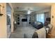 Spacious living room features a ceiling fan, modern furniture, and entertainment center at 114 Madeira Ave, Orlando, FL 32825