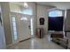 Bright foyer featuring high ceilings, transom windows, and sidelights flanking the front door at 12938 Maribou Cir, Orlando, FL 32828
