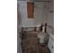 Damaged bathroom with a toilet, missing tiles, and exposed plumbing requiring renovation at 134 Flamingo Dr, Auburndale, FL 33823