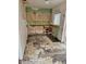 Dilapidated kitchen with missing cabinets, damaged flooring, and exposed plumbing, awaiting renovation at 134 Flamingo Dr, Auburndale, FL 33823