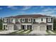 Modern townhome exterior featuring multiple units, individual garages, and manicured landscaping at 134 River Front Way, Edgewater, FL 32141