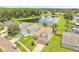 Aerial view of a two-story home with a lake view surrounded by lush trees and greenery at 13404 Bradwater Ct, Orlando, FL 32828