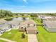 Aerial view of a two-story home with a lake view and a well-manicured lawn and landscape at 13404 Bradwater Ct, Orlando, FL 32828