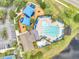 Aerial view of the community pool with lounge chairs and umbrellas, plus playground and clubhouse at 13404 Bradwater Ct, Orlando, FL 32828