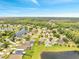 An aerial view showcasing a picturesque neighborhood with lush landscaping, serene lakes, and well-maintained homes at 13404 Bradwater Ct, Orlando, FL 32828