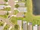 An aerial view of a neighborhood with houses featuring pools and well-maintained lawns near a tranquil lake at 13404 Bradwater Ct, Orlando, FL 32828