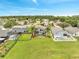 A sprawling backyard with a screened pool, lush lawn, and charming homes offers resort-style living at 13404 Bradwater Ct, Orlando, FL 32828