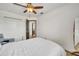 A bright bedroom showcases hardwood floors, closet space, ceiling fan and neutral decor at 13404 Bradwater Ct, Orlando, FL 32828