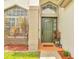 Welcoming front entryway with lush greenery, a decorative brick pillar, and a charming doormat at 13404 Bradwater Ct, Orlando, FL 32828