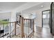 Bright hallway with hardwood floors leads to rooms, with modern railings on the staircase at 13404 Bradwater Ct, Orlando, FL 32828