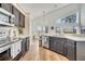 Kitchen view with black cabinets, quartz countertops, stainless steel appliances, and eat-in dining at 13404 Bradwater Ct, Orlando, FL 32828