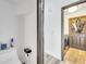 Hallway view of a laundry room featuring modern washer and dryer with an adjacent water closet at 13404 Bradwater Ct, Orlando, FL 32828