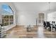 Bright and airy living room featuring hard-surface flooring, modern decor, and a large window at 13404 Bradwater Ct, Orlando, FL 32828