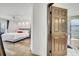 Bright main bedroom featuring wood flooring, a ceiling fan, and access to a bath at 13404 Bradwater Ct, Orlando, FL 32828