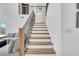 Modern staircase with wooden steps and black iron railings leading to the second floor at 13404 Bradwater Ct, Orlando, FL 32828