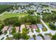 Community aerial view showing the house surrounded by lush greenery and amenities at 142 Stonegate Pass, Davenport, FL 33897