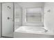 Bathroom offers a separate soaking tub and glass shower enclosure, plus a window for natural light at 142 Stonegate Pass, Davenport, FL 33897