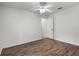 Bedroom features laminate wood-look floors, a ceiling fan, and one door to the hallway at 142 Stonegate Pass, Davenport, FL 33897