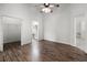 Spacious primary bedroom boasts beautiful wood floors, fan, a walk-in closet and access to a full bathroom at 142 Stonegate Pass, Davenport, FL 33897