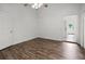 Bedroom has sleek wood floors, a ceiling fan, and natural light. Features a door to the tiled sunroom at 142 Stonegate Pass, Davenport, FL 33897