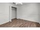 A bright bedroom features wood floors, a ceiling fan, closet and neutral paint at 142 Stonegate Pass, Davenport, FL 33897