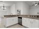 Kitchen area featuring modern appliances, tile countertops, and ample cabinet space at 142 Stonegate Pass, Davenport, FL 33897