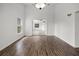 A sunny living room with wood floors offers a view of an adjacent room through an open doorway at 142 Stonegate Pass, Davenport, FL 33897