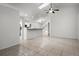 Open-concept layout showcasing the living room with tile flooring and views of the kitchen at 142 Stonegate Pass, Davenport, FL 33897