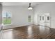 An airy living room features wood floors, recessed lights, and a view of the front yard at 142 Stonegate Pass, Davenport, FL 33897