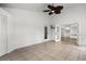 A bright sun room features tile floors, a ceiling fan, and direct access to other rooms and the outdoors at 142 Stonegate Pass, Davenport, FL 33897