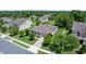 An aerial shot of the home and the surrounding neighborhood with lush trees and well-maintained lawns at 1431 Leitrim Loop, Apopka, FL 32703