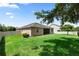 A full shot of the grassy backyard, vinyl privacy fence, and the rear of the home at 1431 Leitrim Loop, Apopka, FL 32703